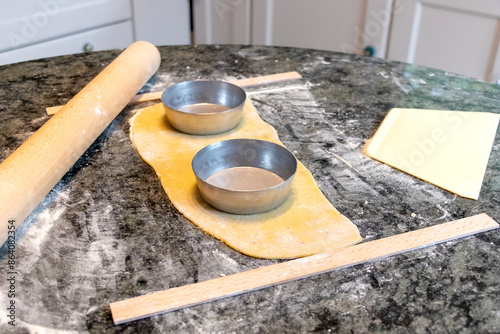 close up of how to make tart pie with dough in the kitchen before baking.   photo