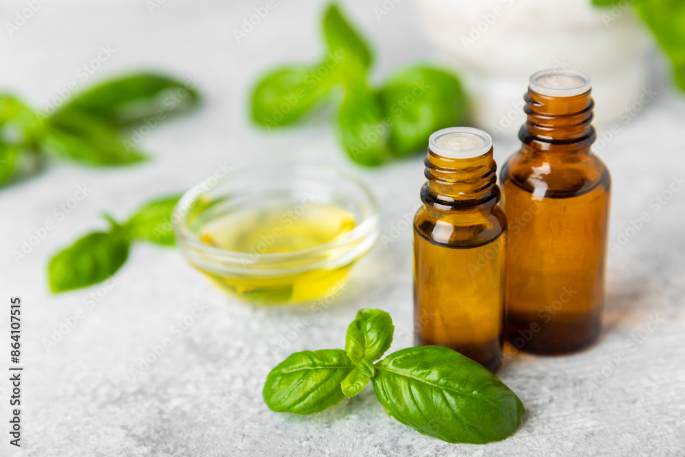 Basil essential oil on a textured wooden background. Basil essential oil and fresh leaves. Aromatherapy. Aroma oil. Medical herbs. Alternative medicine. Place for text. Copy space.