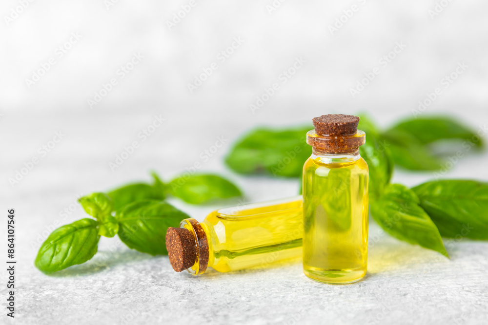 Basil essential oil on a textured wooden background. Basil essential oil and fresh leaves. Aromatherapy. Aroma oil. Medical herbs. Alternative medicine. Place for text. Copy space. Basil essential oil on a textured wooden background. Basil essential oil and fresh leaves. Aromatherapy. Aroma oil. Medical herbs. Alternative medicine. Place for text. Copy space.