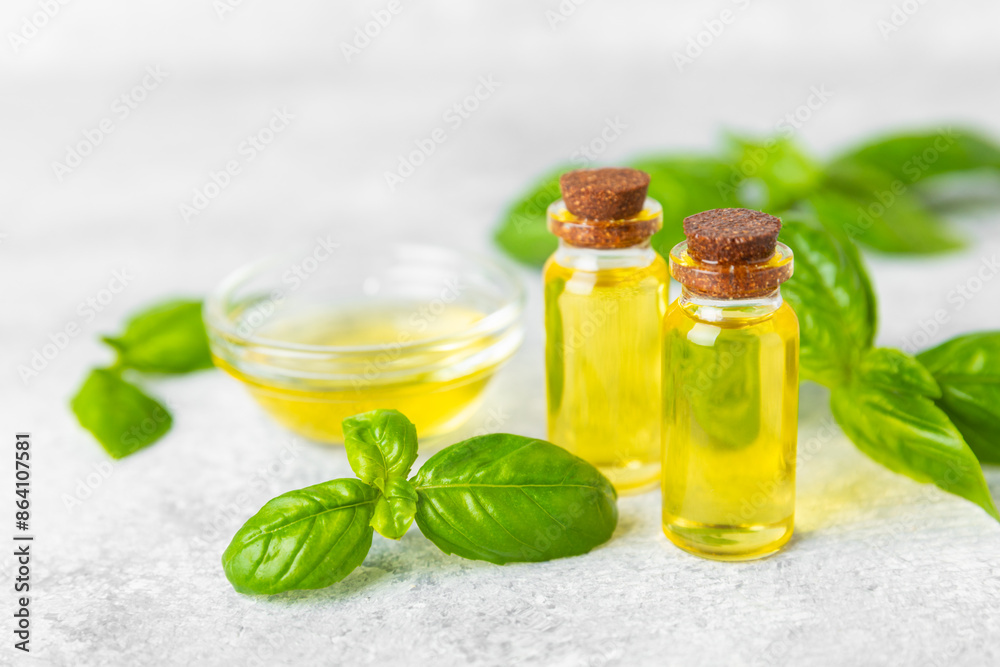 Basil essential oil on a textured wooden background. Basil essential oil and fresh leaves. Aromatherapy. Aroma oil. Medical herbs. Alternative medicine. Place for text. Copy space. Basil essential oil on a textured wooden background. Basil essential oil and fresh leaves. Aromatherapy. Aroma oil. Medical herbs. Alternative medicine. Place for text. Copy space.