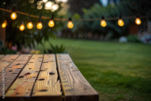 Empty Wood table top with decorative outdoor string lights hanging on trees in the revier nature  at sunset time, photo