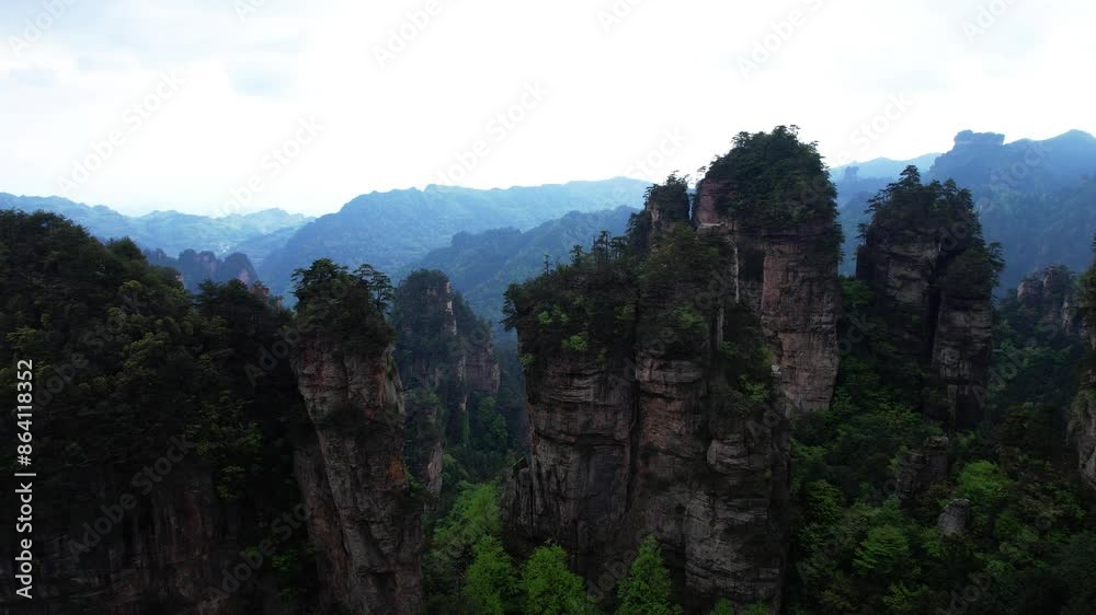 Aerial pan left above Huangshi Village near Five Finger Peak in Zhangjiajie Forest, China Aerial pan left above Huangshi Village near Five Finger Peak in Zhangjiajie Forest, China