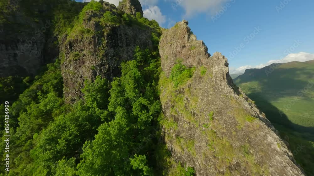 Drone cruising up the cliffs of the landmark Le Morne Brabant. Drone cruising up the cliffs of the landmark Le Morne Brabant.