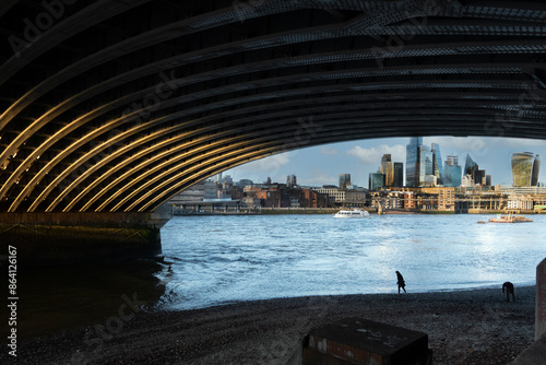 Beachcombers stroll beneath Blackfriars Bridge on the South Bank of the River Thames, London, England, United Kingdom, Europe photo