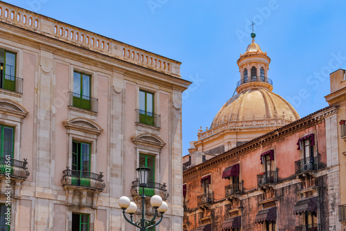 Abbey of St. Agatha cupola behind historic buildings with iron balconies in Catania, Sicily, Italy, Mediterranean, Europe photo