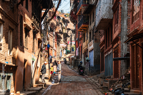 View along a narrow alley road with traditional brick houses in the center of Bhaktapur, Kathmandu, Nepal, Asia photo