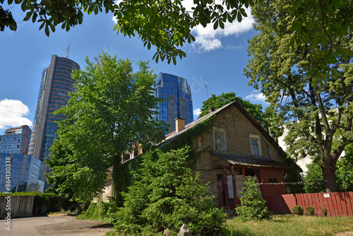 Old houses surrounded by modern office towers in the Snipiskes district, Vilnius, Lithuania, Europe photo