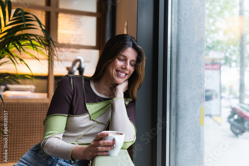 Free Download Thoughtful good-looking lady dreamy looking out the window cafeteria - GFXLoad