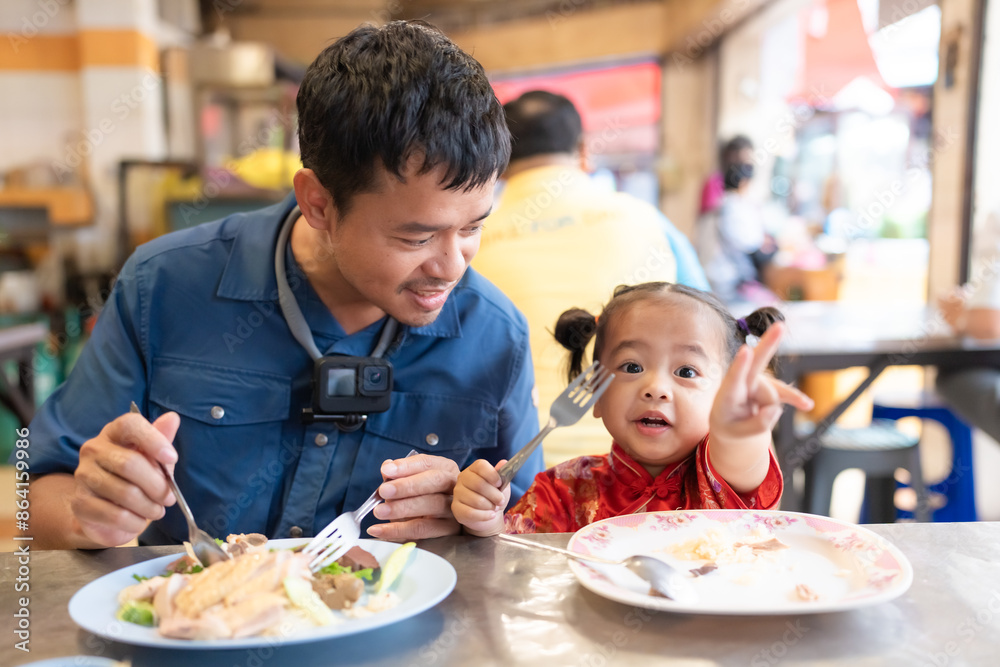 Adorable little asian girl eat steam rice with dad on street food local city Yaowarat Adorable little asian girl eat steam rice with dad on street food local city Yaowarat