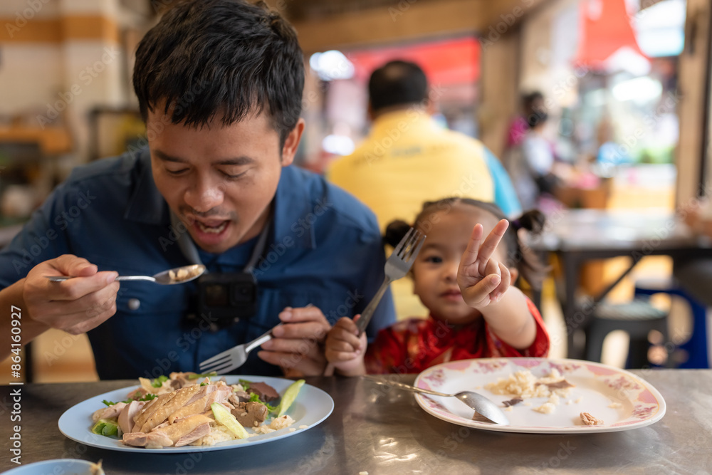 Adorable little asian girl eat steam rice with dad on street food local city Yaowarat Adorable little asian girl eat steam rice with dad on street food local city Yaowarat