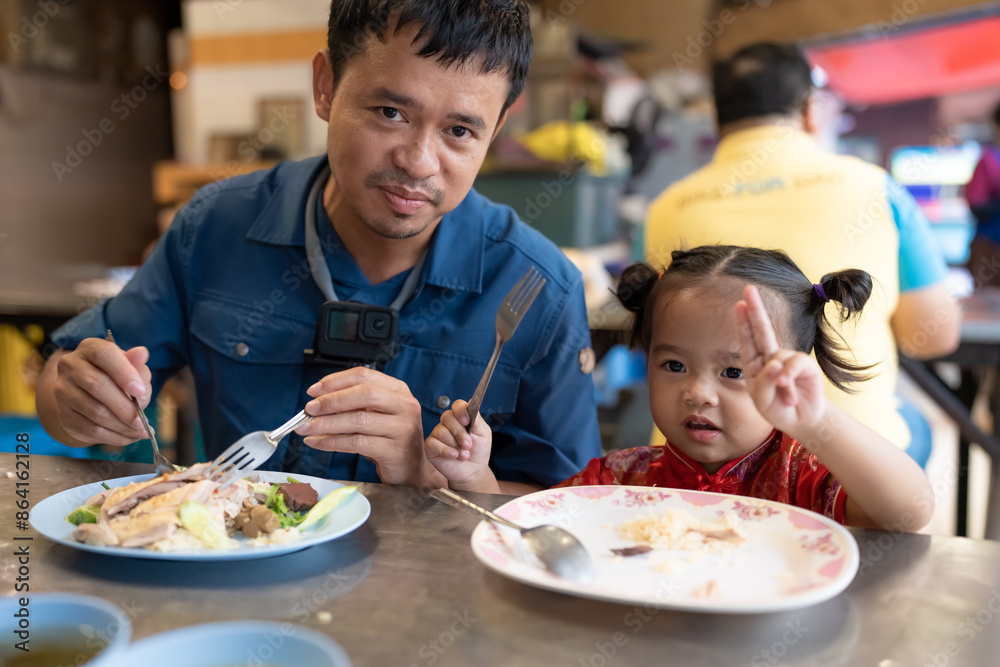 Adorable little asian girl eat steam rice with dad on street food local city Yaowarat Adorable little asian girl eat steam rice with dad on street food local city Yaowarat