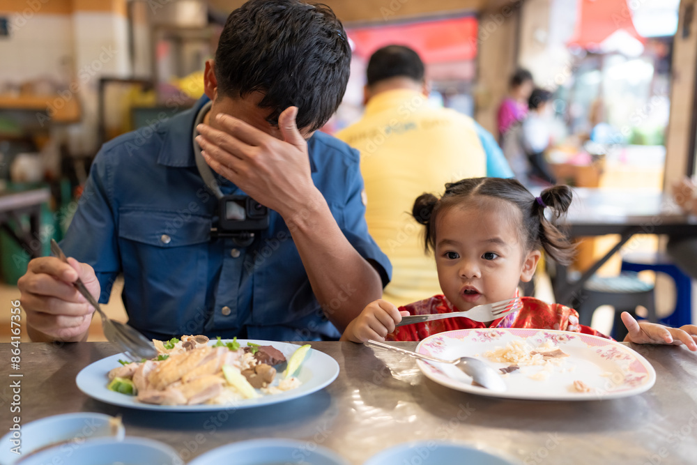 Adorable little asian girl eat steam rice with dad on street food local city Yaowarat Adorable little asian girl eat steam rice with dad on street food local city Yaowarat