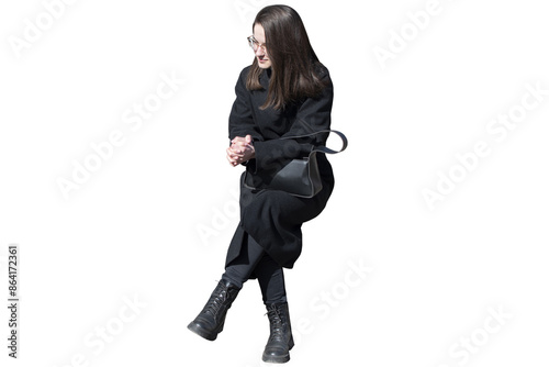 A woman in black coat in sitting pose isolated	