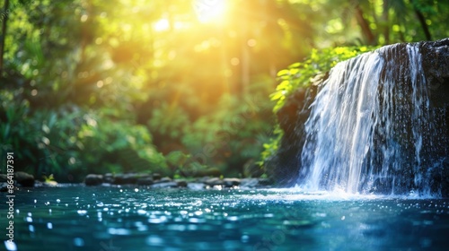 Fototapeta Naklejka Na Ścianę i Meble -  A serene tropical waterfall surrounded by lush greenery in a sunlit jungle, with sunlight streaming through the trees.