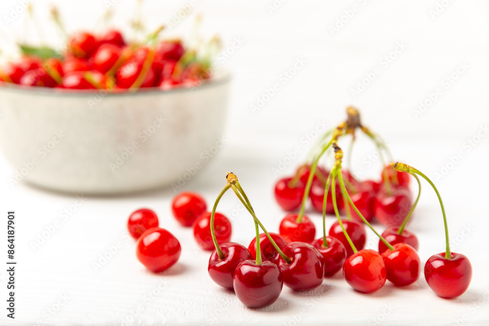 Cherries. Fresh ripe cherries with leaves on a textured wooden background. Fresh sweet organic cherry pile. Berries and fruits. Vegan. Healthy eating. Place for text. Copy space Cherries. Fresh ripe cherries with leaves on a textured wooden background. Fresh sweet organic cherry pile. Berries and fruits. Vegan. Healthy eating. Place for text. Copy space