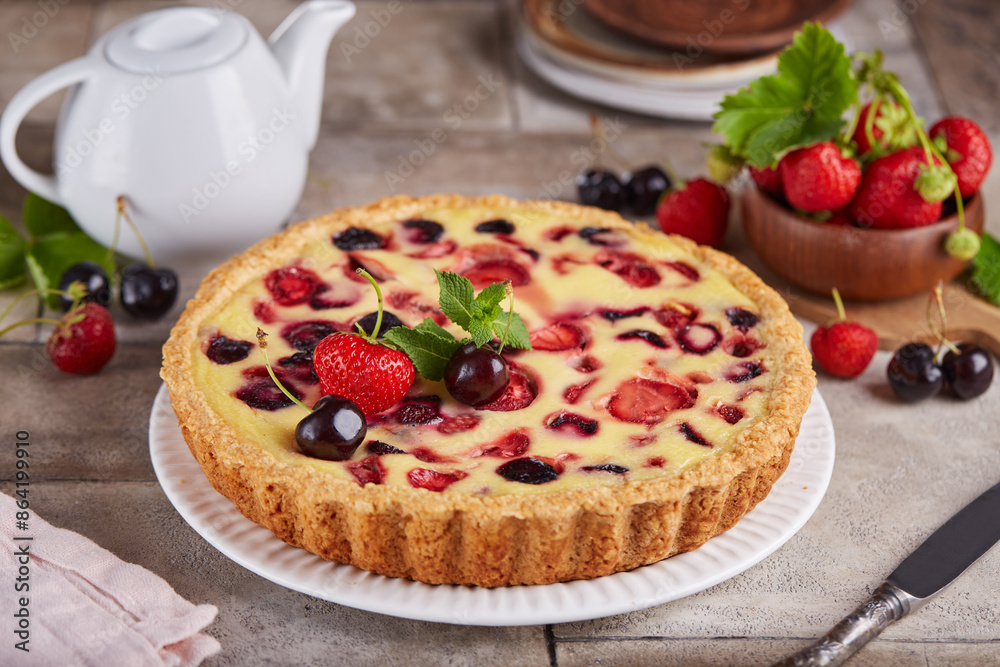 Tart with cherries strawberries and custard milk cream filling. Open cheesecake pie. Delicious homemade summer dessert with berries. Tart with cherries strawberries and custard milk cream filling. Open cheesecake pie. Delicious homemade summer dessert with berries.