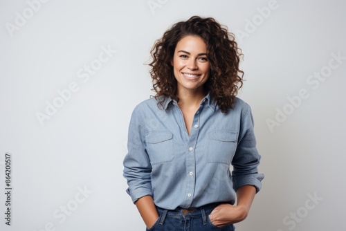 Portrait of a blissful woman in her 30s sporting a versatile denim shirt isolated in white background