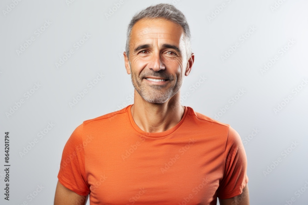Portrait of a grinning man in his 40s sporting a breathable mesh jersey in front of white background