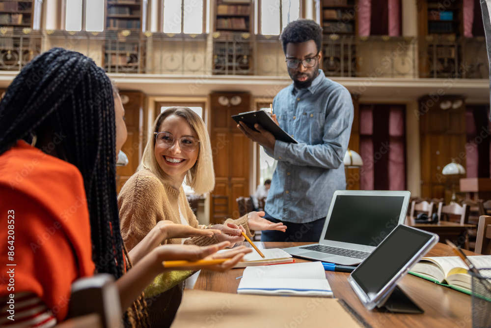 Students work in university library and looking involved Students work in university library and looking involved