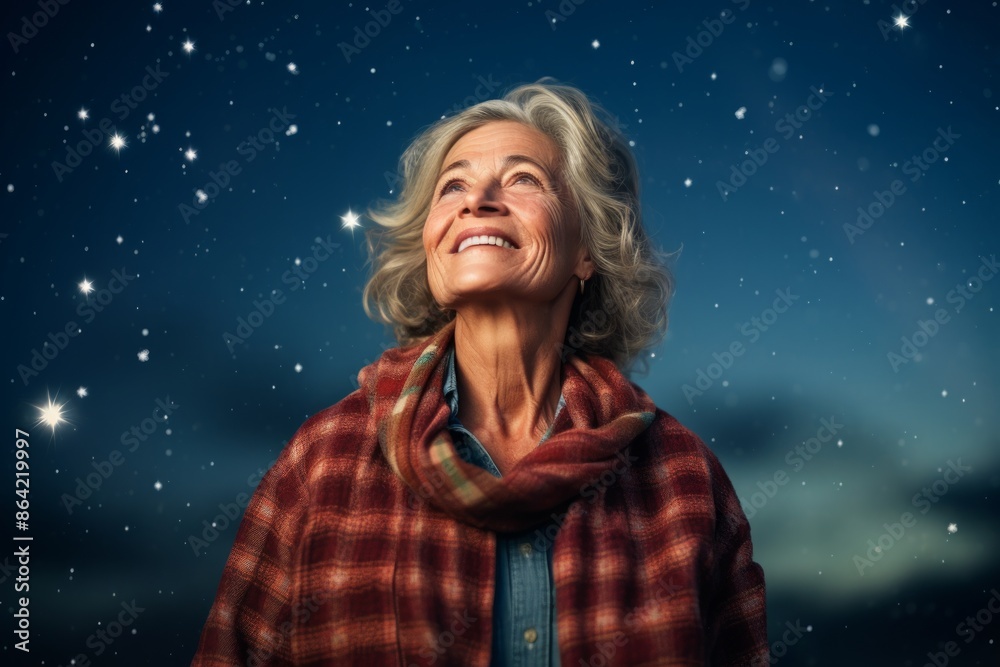 Portrait of a happy woman in her 80s wearing a comfy flannel shirt isolated on sparkling night sky Portrait of a happy woman in her 80s wearing a comfy flannel shirt isolated on sparkling night sky