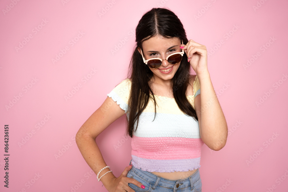 Photo of shiny impressed young woman wearing sunglasses isolated on pink background. Photo of shiny impressed young woman wearing sunglasses isolated on pink background.