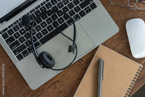 The headphones placed on the laptop after the online meeting has ended.