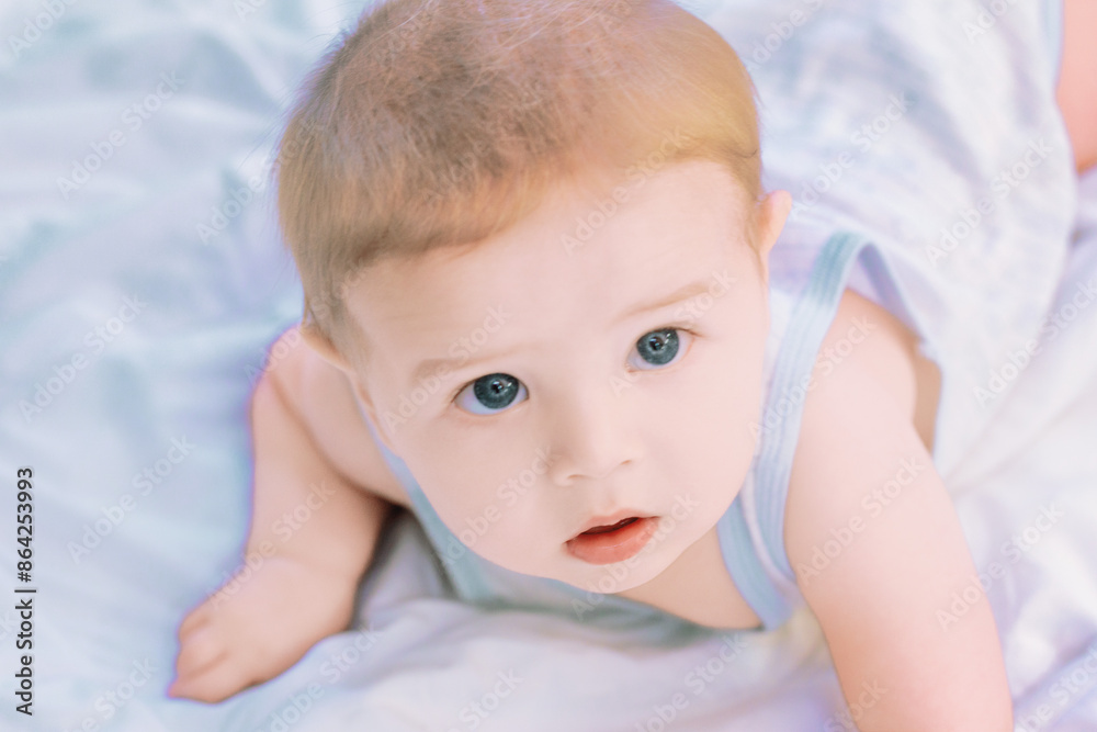 Cute baby boy lying on stomach and looking up Cute baby boy lying on stomach and looking up