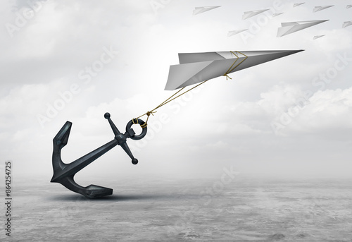 Photography Obstructed From Opportunity and Obstruction to progress as a metaphor or dragged down business concept as a paper plane symbol impeded and restricted