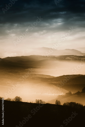 misty hills in autumn morni...