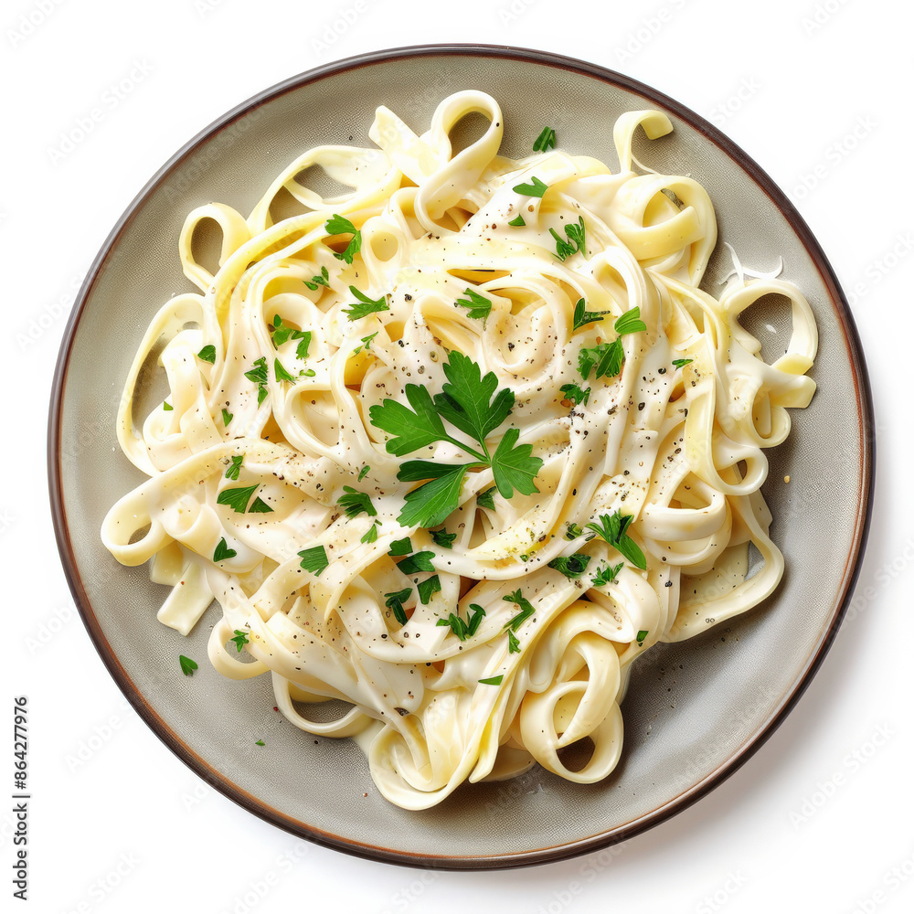 A plate of creamy fettuccine alfredo with fresh parsley, isolated on white background A plate of creamy fettuccine alfredo with fresh parsley, isolated on white background