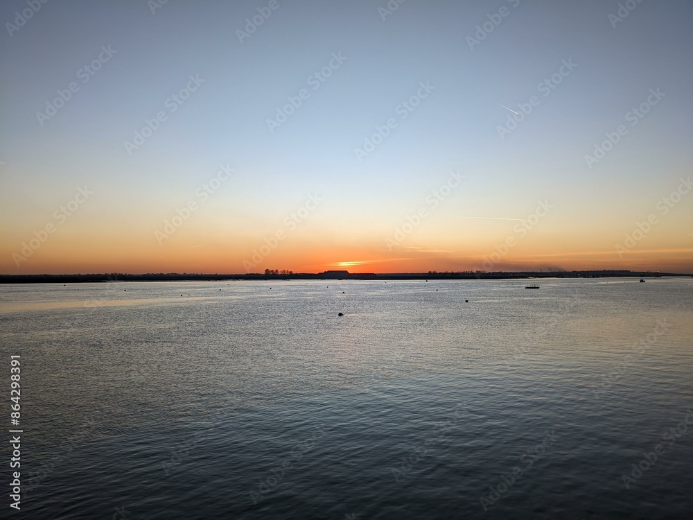 Sunset over the River Crouch at Burnham-on-Crouch in Essex, UK Sunset over the River Crouch at Burnham-on-Crouch in Essex, UK