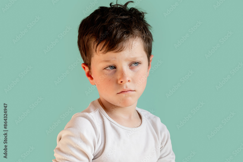Serious young boy looking away in a studio setting Serious young boy looking away in a studio setting