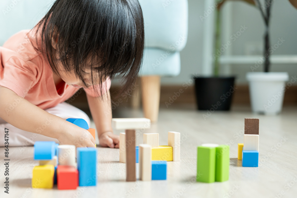Happy Asian child playing and learning toy blocks. children are very happy and excited at home. child have a great time playing, activities, development, attention deficit hyperactivity disorder Happy Asian child playing and learning toy blocks. children are very happy and excited at home. child have a great time playing, activities, development, attention deficit hyperactivity disorder