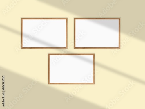 Mockup withl picture frames side by side on a wall, close up, bright