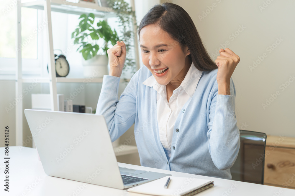 Excited with computer, happy celebrating success asian young woman, girl amazed looking good news at pc, laptop on desk at home office, get win online lottery, student winner celebrating achievement.