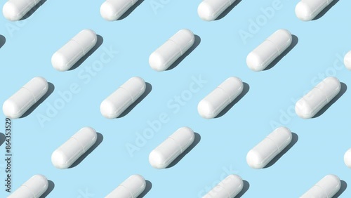 White capsule pills on blue background , Medicine concept. Pattern with capsule pills slow motion 4k video.