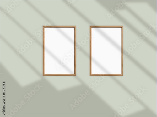 Minimal picture poster frame mockup on the wall with window shadow and leaves