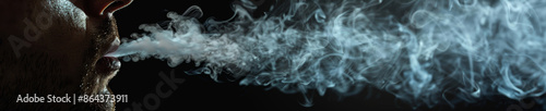 Close Up of Man Exhaling Smoke Against Black Background