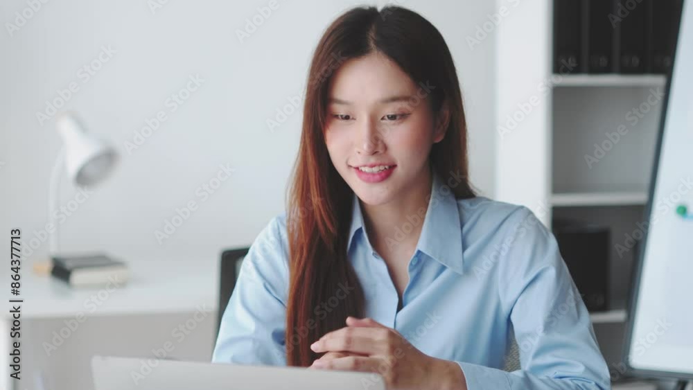 Young woman working and communicating in a modern office. Engaging with laptop, whiteboard, and documents. Business environment with a focus on productivity and efficiency Young woman working and communicating in a modern office. Engaging with laptop, whiteboard, and documents. Business environment with a focus on productivity and efficiency