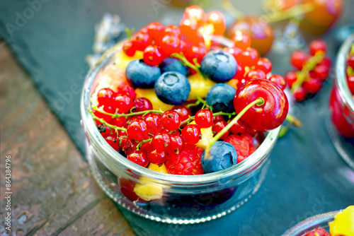 Organic berries in a glass bowl, healthy vegetarian food