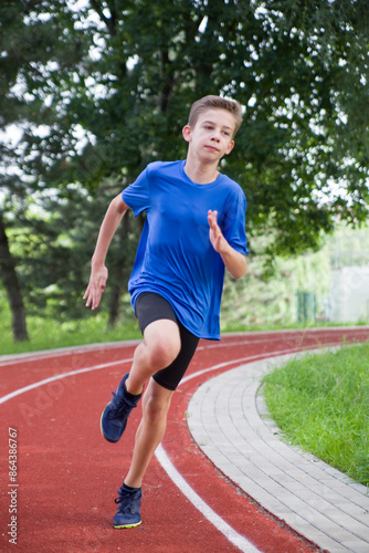 An athlete runs along a stadium bend.
