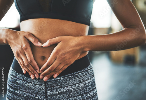 Obraz na plátne Health, digestion and hands on stomach for woman in gym, nutrition and gut support detox
