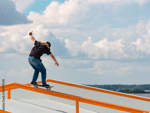 Young man doing jump trick on skateboard