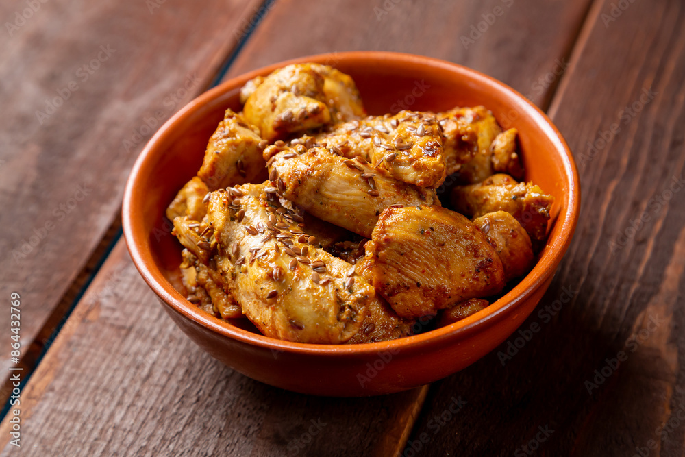 chicken stewed in spices in a clay bowl on the table chicken stewed in spices in a clay bowl on the table
