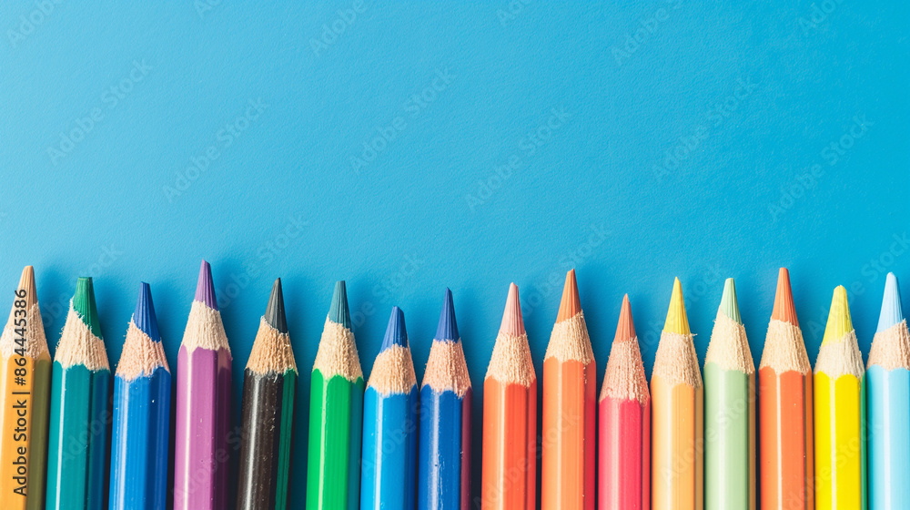 Row of multi-colored pencils on a pink, blue, red and yellow backgrounds Row of multi-colored pencils on a pink, blue, red and yellow backgrounds
