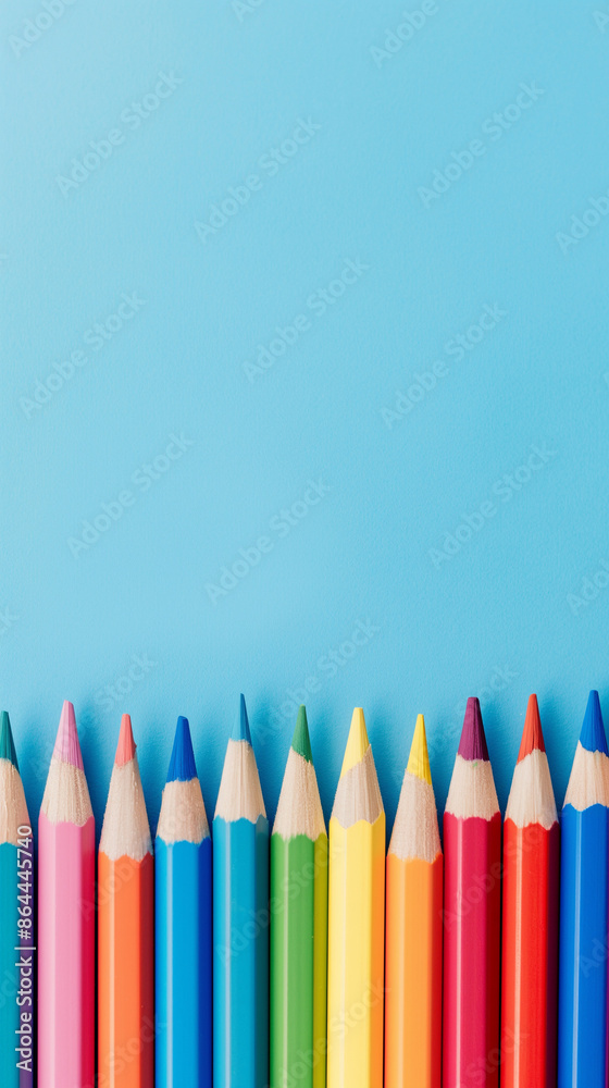 Row of multi-colored pencils on a pink, blue, red and yellow backgrounds Row of multi-colored pencils on a pink, blue, red and yellow backgrounds