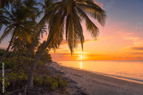 Fototapeta Naklejka Na Ścianę i Meble -  Beach with sunrise or sunset and quiet ocean in Maldives. Golden hour in paradise island
