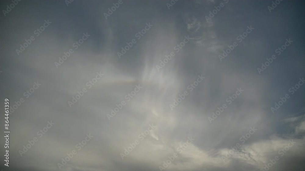Sky background with moving texture of Cirrus clouds, colorful arc of halo around sun and flock of birds in flight - timelapse. Topics: optical phenomenon, atmosphere, texture, weather, meteorology Sky background with moving texture of Cirrus clouds, colorful arc of halo around sun and flock of birds in flight - timelapse. Topics: optical phenomenon, atmosphere, texture, weather, meteorology