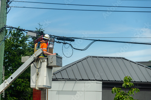 Telecommunications technician at work on a overhead line