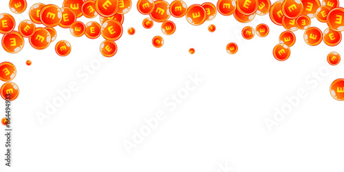 Vitamin E round capsules scattered randomly.